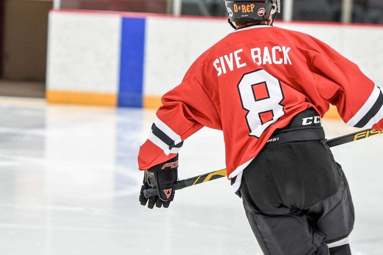 man skating with dawg nation hockey jersey on